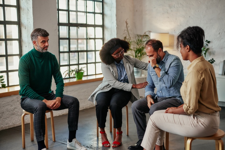 Individuals supporting each other during group therapy for substance abuse in Los Angeles, CA